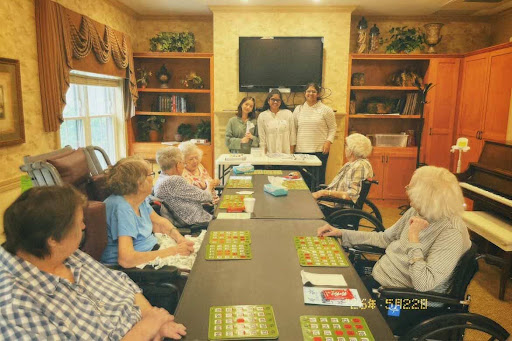 Volunteers hosting a bingo night with elder care residents