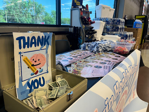 Fundraising table with donation box and thank you sign